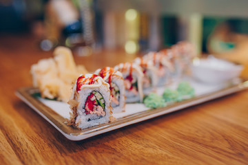 Close-up Kyoto eel smoked philadelphia Red Green dragon California ,Ebi Roll Rainbow Set rolls assorti in night dining restaurant. Delicious Sushi rolls served in a bar. The norwegian eel salmon Fish.