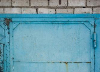blue metal grunge closed door in brick wall