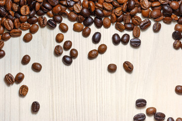 Coffee beans on a light wooden table