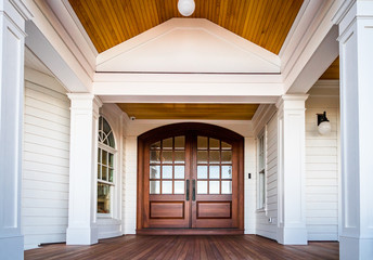 Front entry way of house featuring PVC trim, woodwork, columns, and deck