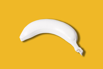 white colored banana isolated on yellow background