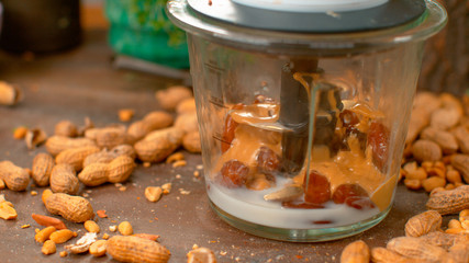 MACRO, DOF: Dried dates, fresh milk, and peanut butter sit inside a blender.