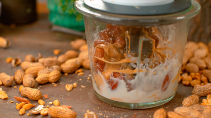 MACRO: Kitchen blender mixes salty peanut butter with milk and sweet dried dates