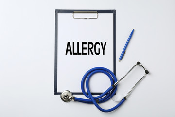 Clipboard with space for text, pen and stethoscope on white background, top view. Medical objects