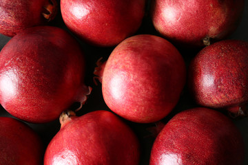 Delicious red ripe pomegranates on table, top view