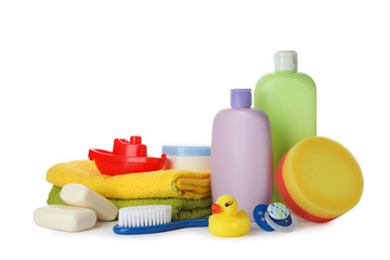 Baby cosmetic products, toys and towels on white background