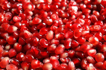 Fresh juicy pomegranate seeds as background, closeup