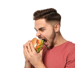 Handsome man eating tasty burger isolated on white