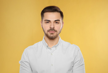 Portrait of handsome young man on color background