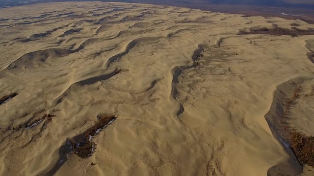 Aerial helicopter high Chara Sands Desert Siberia tundra Nature landscape structure yellow sand dunes Udokan mountain ranges Trans-Baikal. Russia Best place unique extreme tourism. Winter