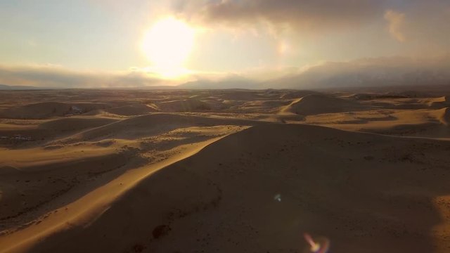 Aerial helicopter Chara Desert Sands dunes Nature miracle south-east Siberia tundra Bright yellow golden sand Travel Trans-Baikal Russia Kodar Sakukan glacier Sight. Sunset orange rays Clouds Rainbow 