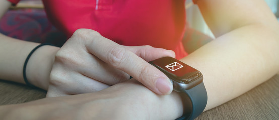 woman use smart watch to check unread electronic , e-mail for checking work, job, entertainment, news in the social network