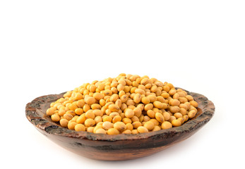 Raw dried soybeans on white background.