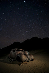 Rusting vintage car under the stars