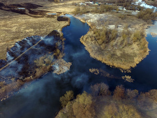 The smoke from the burning of dry grass (drone image).Local residents set fire to the grass...