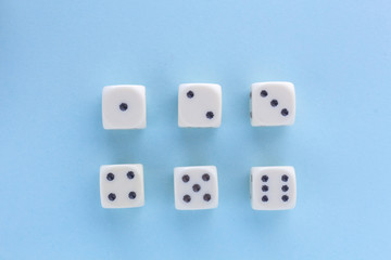 White gaming dices on light blue background. victory chance and lucky. Flat lay style, place for text. Top view and Close-up cube. Concept business, gamble and game. Spectacular background pastel.