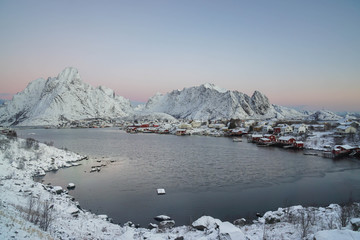 nature landscape of red wooden house in Reine village in sunrise in winter