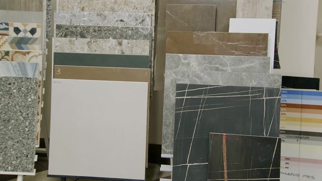 samples of ceramic tile with different design, colours and patterns in warehouse