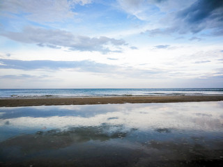 the sky has cloud in the day,it refect with water of the sea 