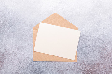 Fototapeta premium Blank paper with envelope on grey background
