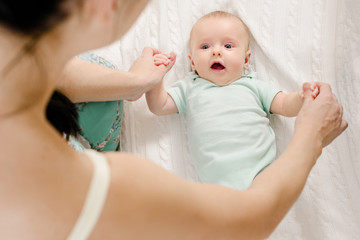 Closeup photo of mother's hands holding cute newborn baby