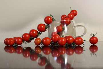 A branch of ripe tomatoes lying on the table