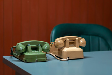 Old landline phone on the desk. They are manufactured from the 19th century as a means of communication by voice at that time