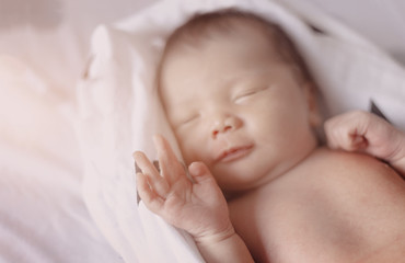 good dreaming new born baby sleep on white towel