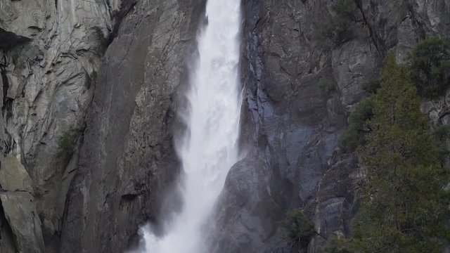 Slow motion pan down shot of lower Yosemite falls in early Spring.