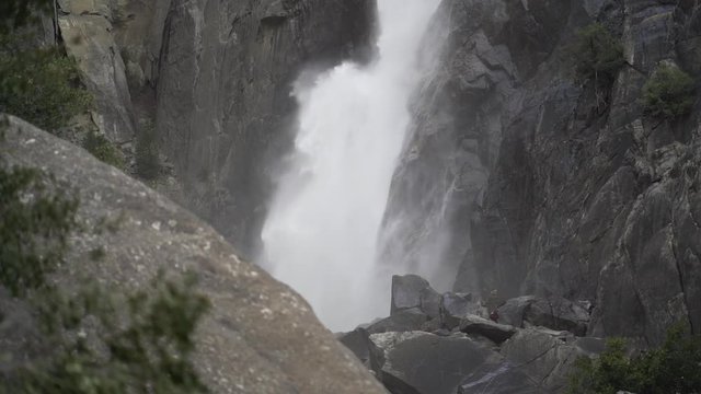 Closeup slow motion shot of lower Yosemite falls in early spring snow melt runoff
