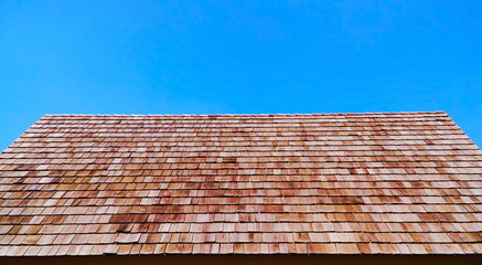 Red roof and blue sky, The roof of the house made of wood with blue background.