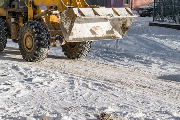 Snow removal snow machine on the road in winter or spring