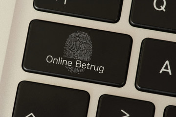 Ein Computer, Fingerabdruck und Warnung vor Online Betrug