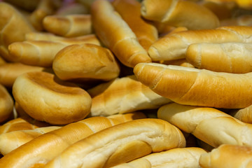 Wheat buns background. Closeup, selective focus