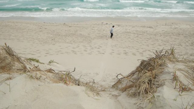 Adult male sandboarding at beach