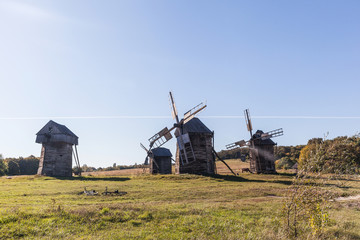 Fototapeta na wymiar windmill in the steppe, old straw hut, beautiful nature, desktop wallpaper