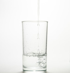 Close up pouring purified fresh drink water from the bottle 