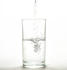 Close up pouring purified fresh drink water from the bottle 
