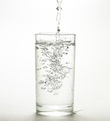 Close up pouring purified fresh drink water from the bottle 