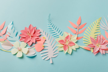 Paper craft origami fower decoration creative idea. tropical Flowers and leaves on blue pastel background, summertime, evegreen modern trendy concept