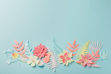 Muted color colorful flower composition - handmade papercraft flowers and leaves on pastel blue background, spring, summer, easter, holiday modern concept