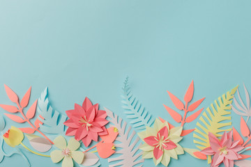 Paper craft origami fower decoration creative idea. tropical Flowers and leaves on blue pastel background, summertime, evegreen modern trendy concept