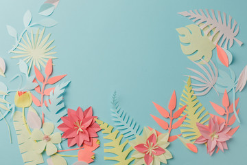 Muted color colorful flower composition - handmade papercraft flowers and leaves on pastel blue background, spring, summer, easter, holiday modern concept
