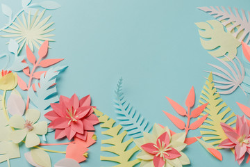Muted color colorful flower composition - handmade papercraft flowers and leaves on pastel blue background, spring, summer, easter, holiday modern concept