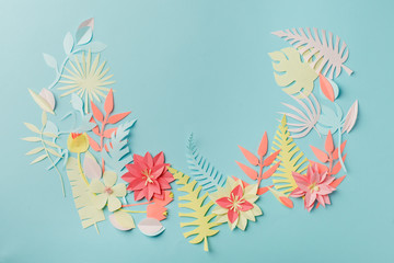 Paper craft origami fower decoration creative idea. tropical Flowers and leaves on blue pastel background, summertime, evegreen modern trendy concept