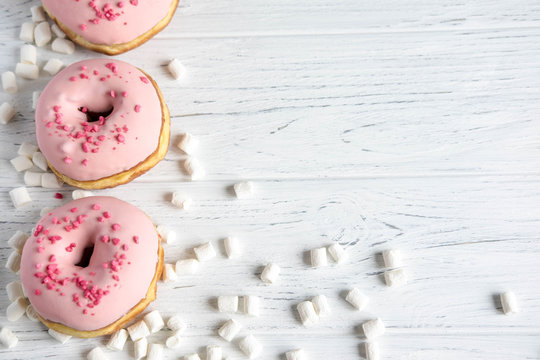 Photo of pink donuts on a white background. Frame for text with donuts and sweets. Basis for a banner with donuts. Banner with donuts for social networks, shops, cafes