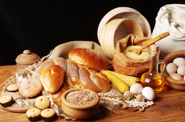 Baked goods, flour, corn on a dark background.