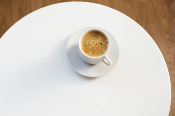 cup of coffee on white table