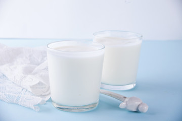 Yogurt in glass on a table with white napkin.