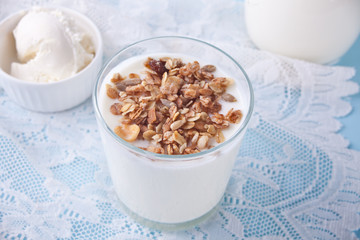 Granola with yogurt in glass on a white napkin